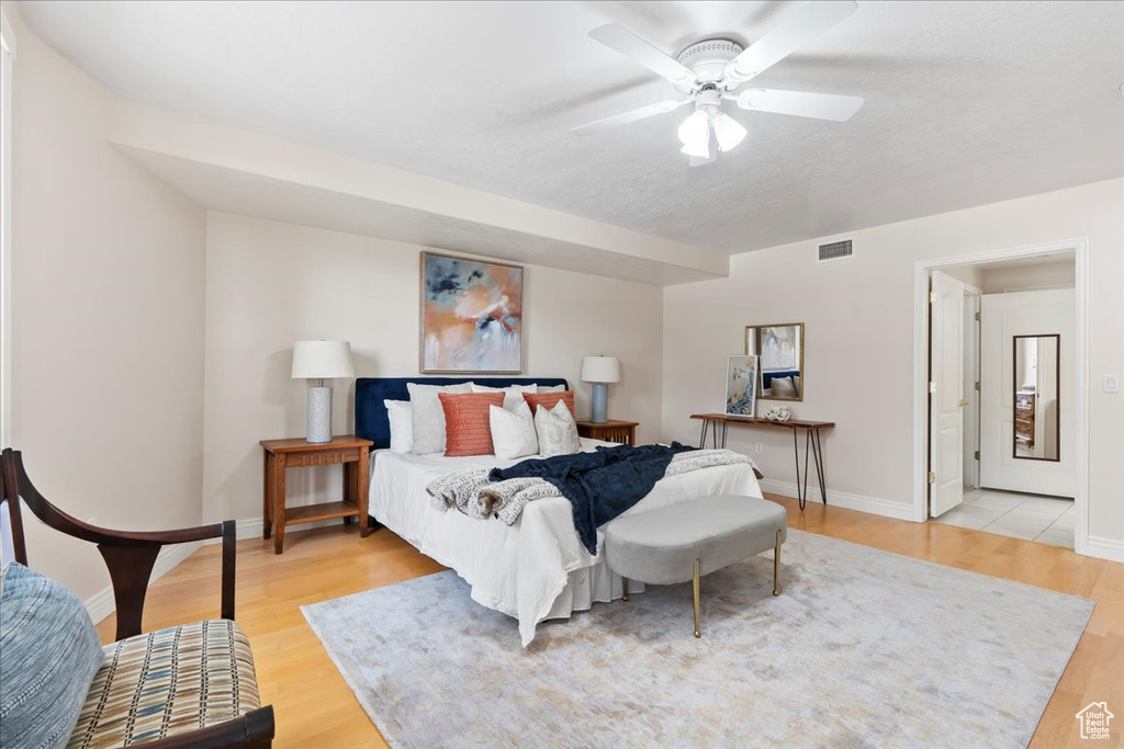Bedroom featuring light wood-style flooring, baseboards, and ceiling fan