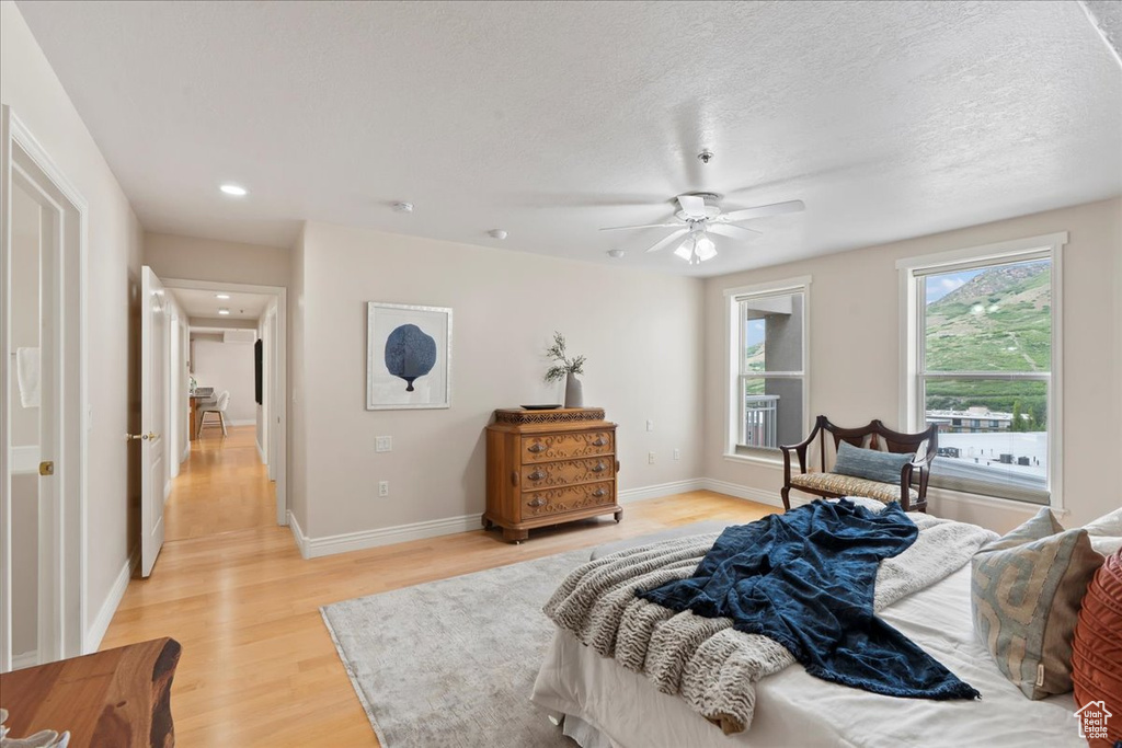 Bedroom featuring light wood-type flooring, baseboards, a ceiling fan, and recessed lighting