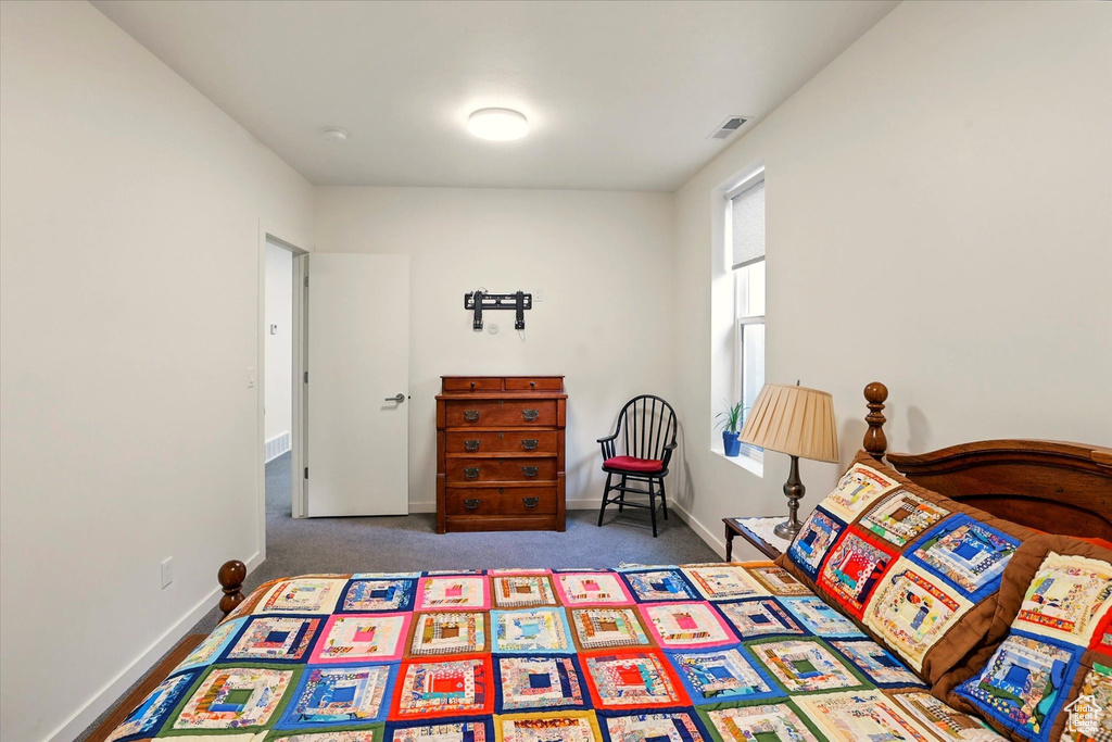 Carpeted bedroom featuring baseboards