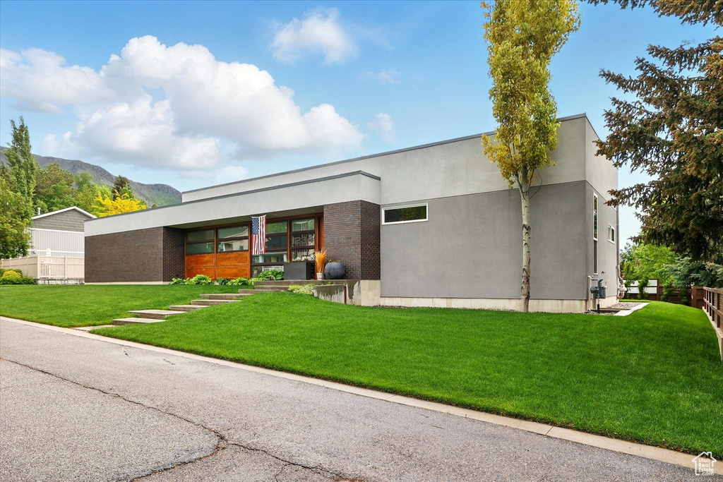 View of front of house featuring a mountain view and stucco siding
