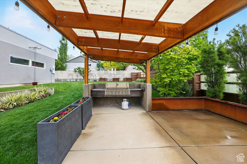 View of patio / terrace featuring exterior kitchen and a grill