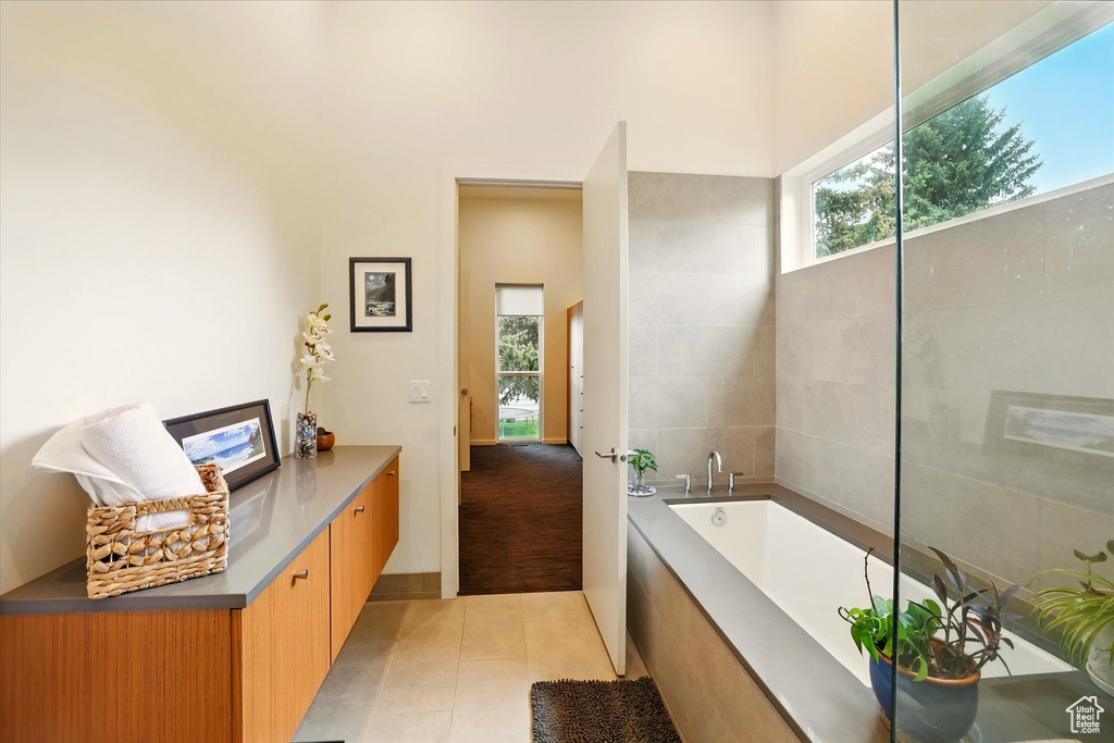 Full bathroom with tile patterned floors and a bath