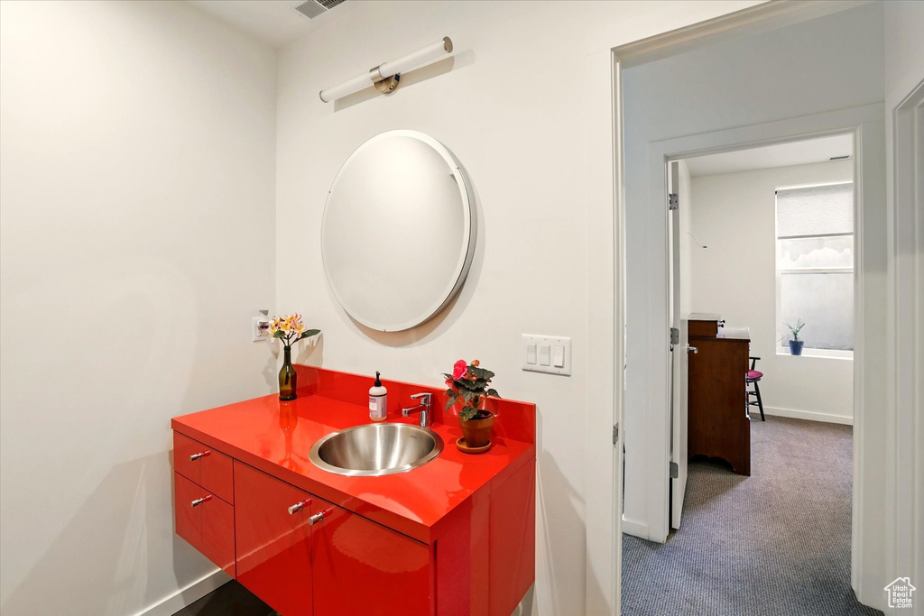 Bathroom with vanity and baseboards