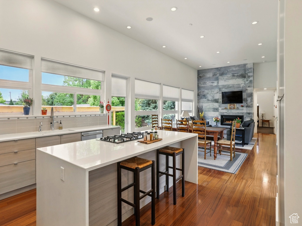 Kitchen featuring a sink, modern cabinets, recessed lighting, stainless steel appliances, and a kitchen island
