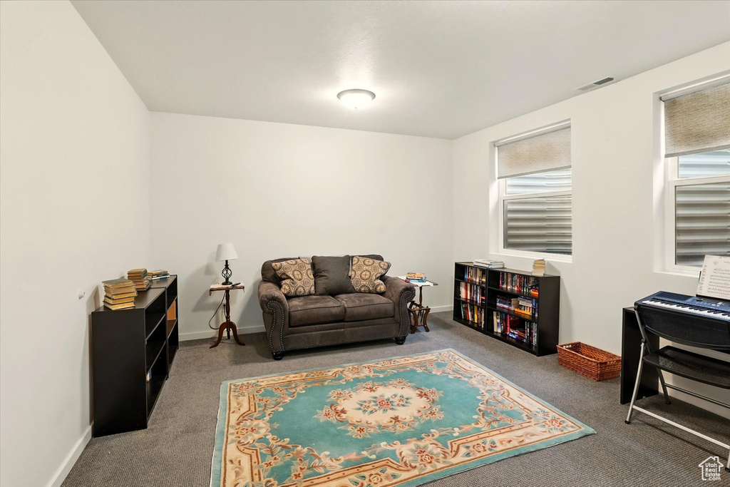 Living area with carpet floors and baseboards