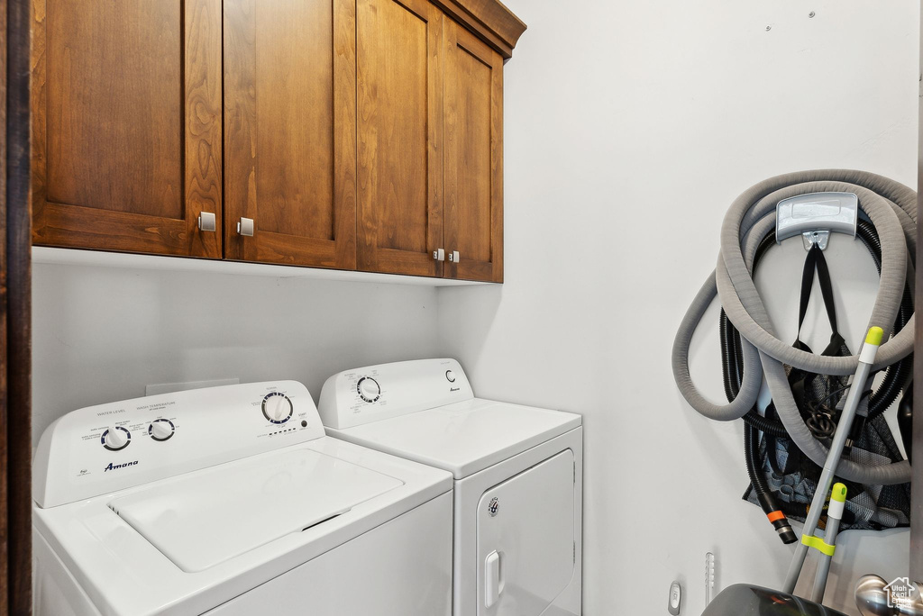 Laundry area featuring cabinet space and washer and dryer