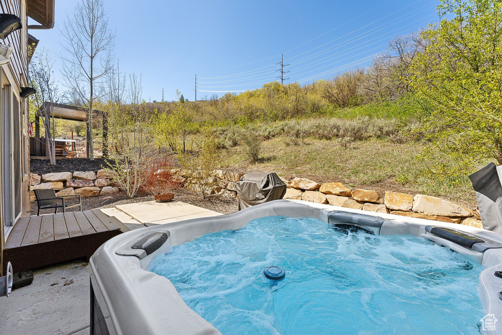 View of pool featuring a hot tub