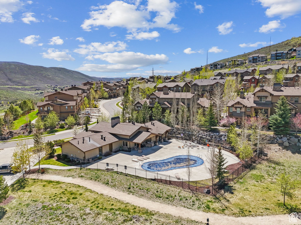Aerial view of residential area with mountains and a pool area