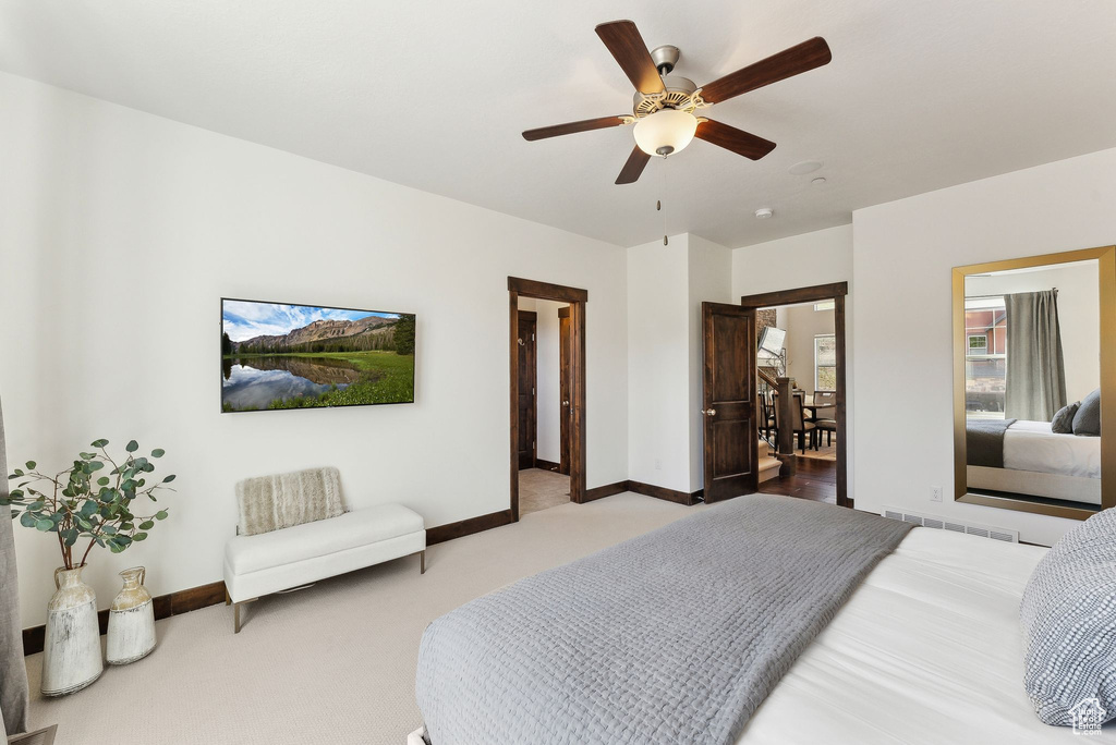 Carpeted bedroom with baseboards and ceiling fan
