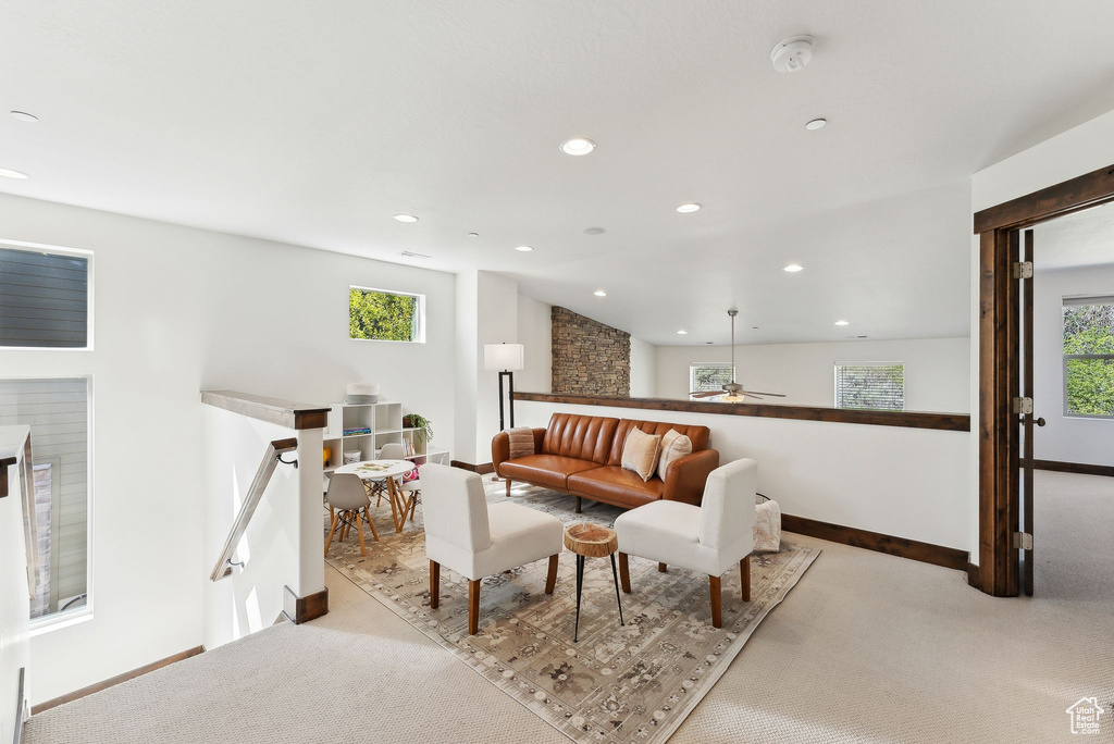 Living area with baseboards, light carpet, recessed lighting, and ceiling fan