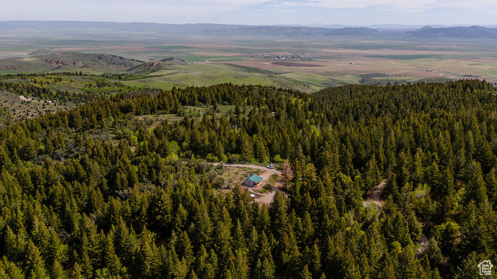 View of property location with a forest and a mountain backdrop