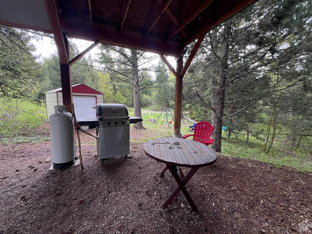 View of patio / terrace with area for grilling and an outbuilding
