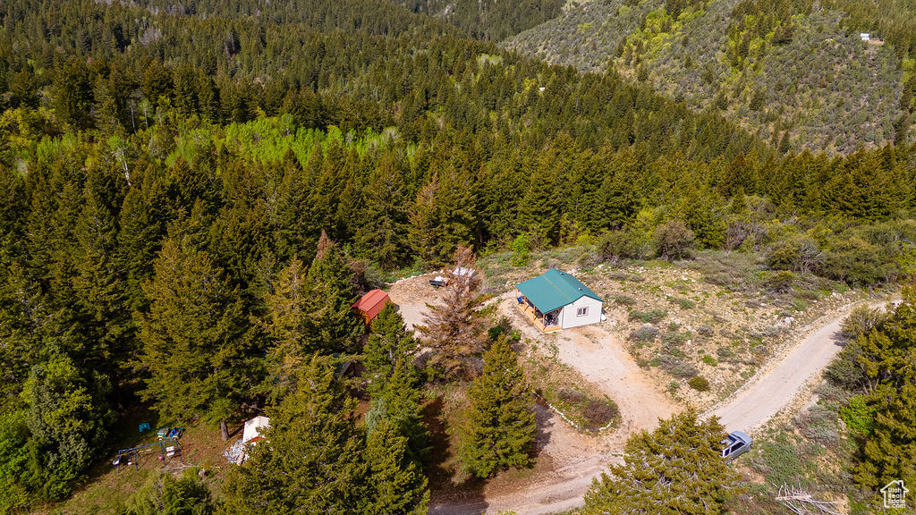 View from above of property featuring a heavily wooded area