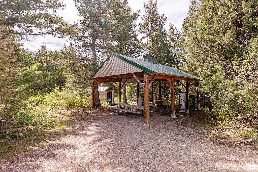 View of home\\\'s community with a gazebo, an outdoor structure, and a shed