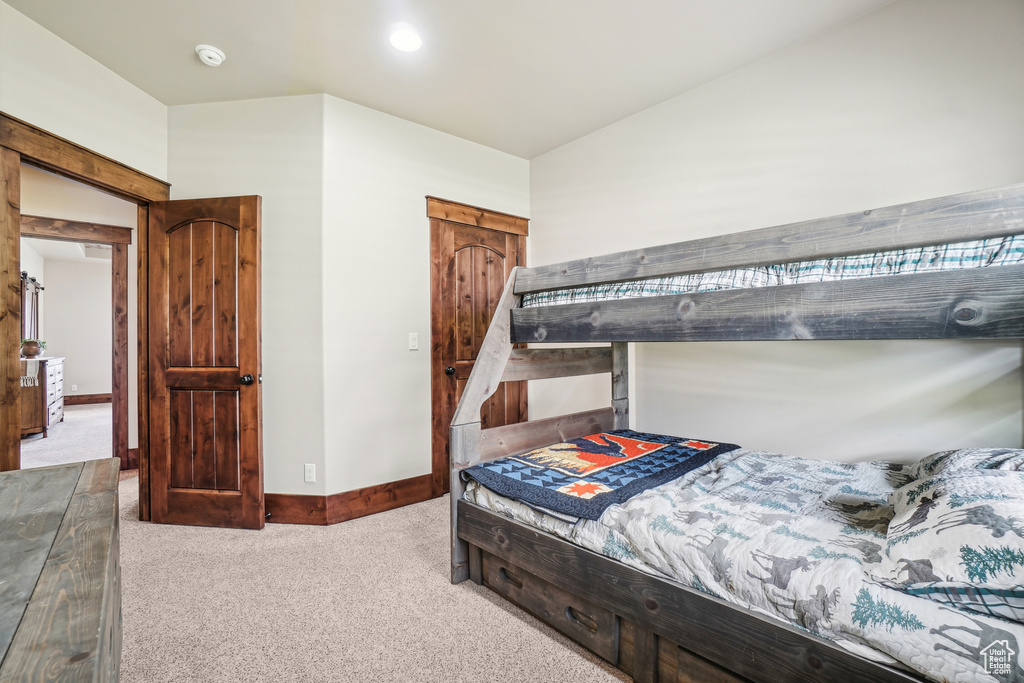 Bedroom featuring carpet flooring and baseboards