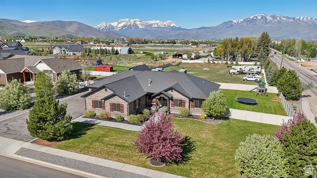 Aerial view of property and surrounding area featuring a mountainous background