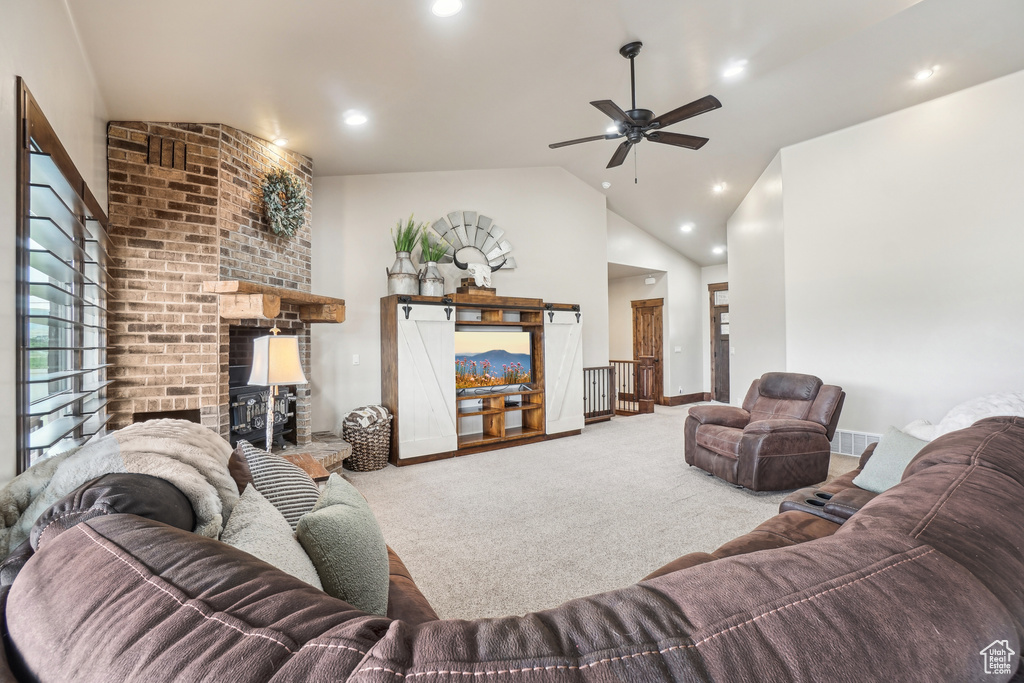 Living area featuring carpet, a brick fireplace, lofted ceiling, ceiling fan, and recessed lighting