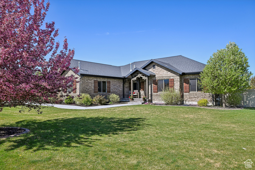 View of front facade featuring brick siding and a front lawn
