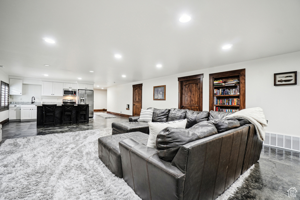 Living area featuring recessed lighting and baseboards