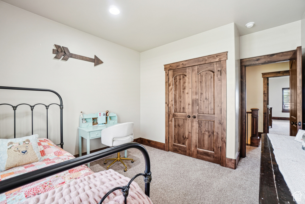 Carpeted bedroom featuring baseboards