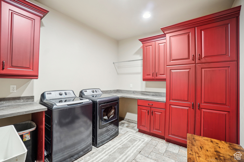 Laundry room featuring cabinet space, washing machine and dryer, recessed lighting, and a desk