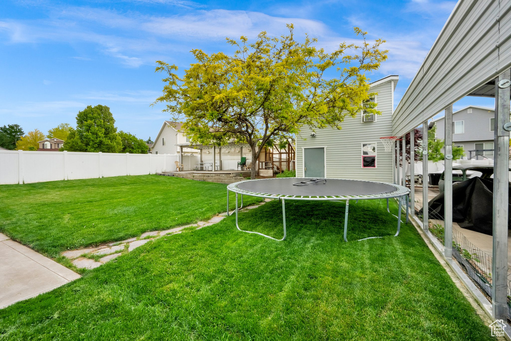 View of yard featuring a trampoline
