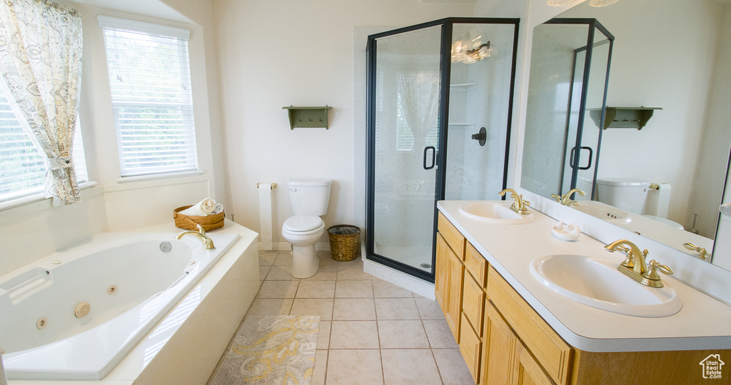 Bathroom with toilet, a whirlpool tub, a stall shower, double vanity, and tile patterned flooring