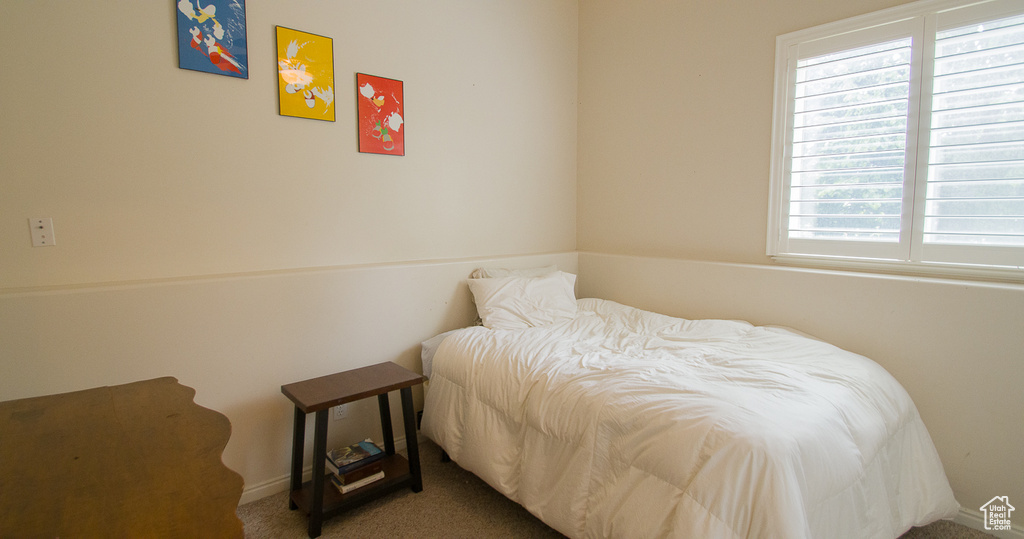 Carpeted bedroom featuring baseboards