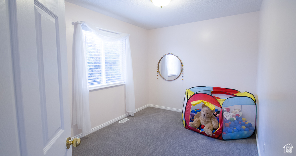 Game room with carpet flooring and baseboards