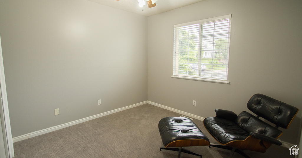 Sitting room with baseboards, carpet, and ceiling fan