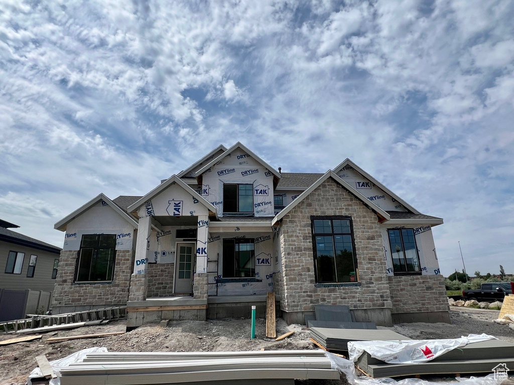 Property in mid-construction featuring stone siding