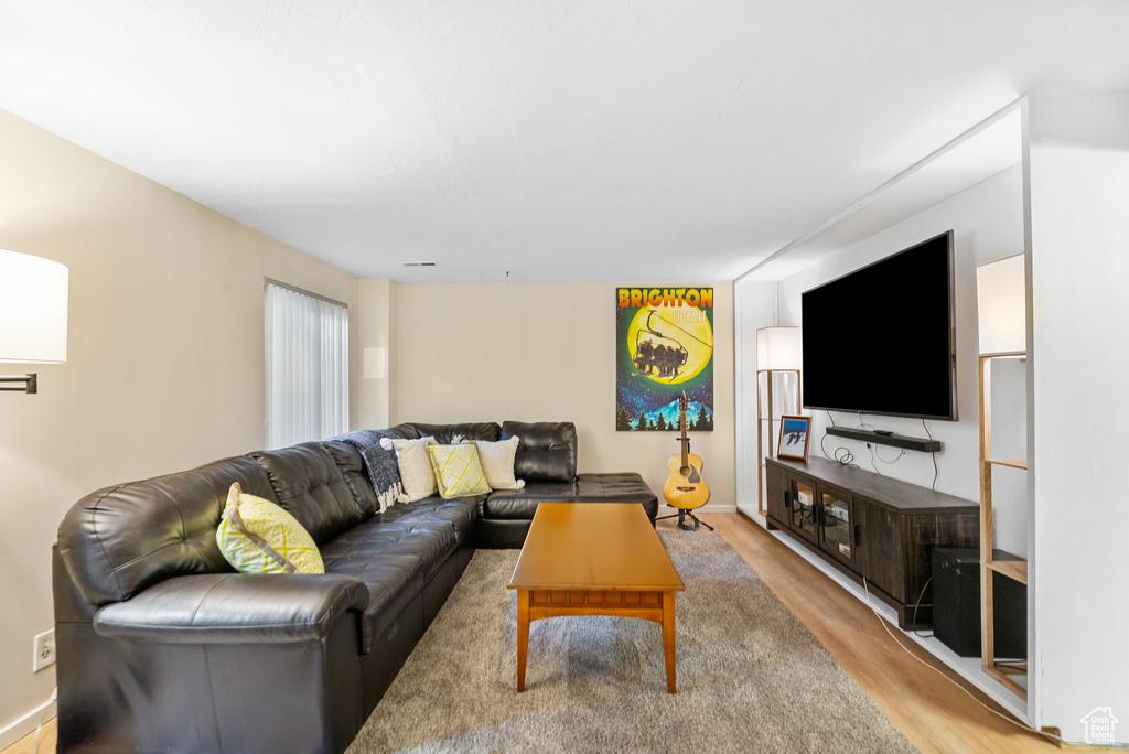 Living area with light wood finished floors and baseboards