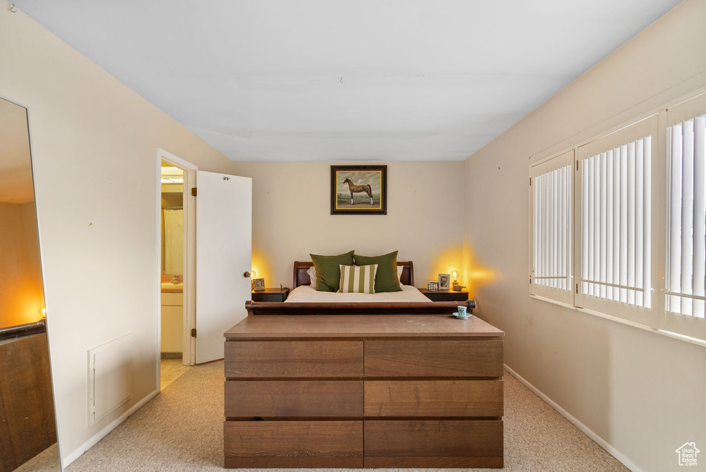 Bedroom with light carpet and baseboards