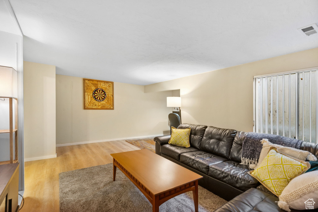 Living room with light wood-type flooring and baseboards