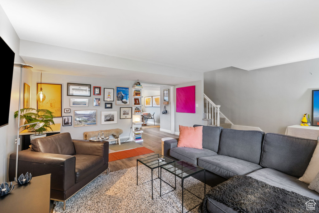Living area featuring wood finished floors and stairway