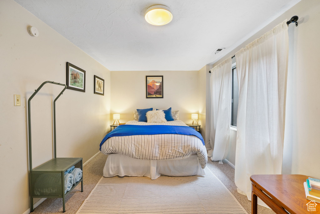 Bedroom with carpet and baseboards