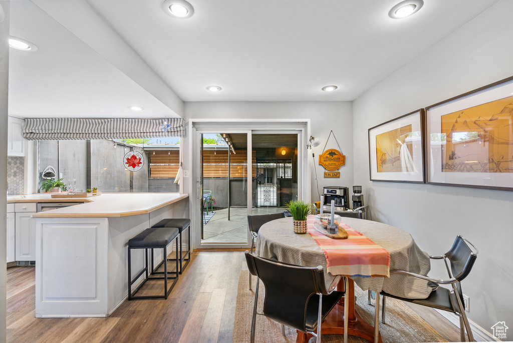 Dining space featuring light wood-style flooring and recessed lighting