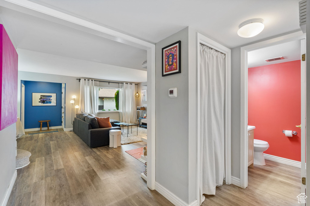 Corridor featuring wood finished floors and baseboards