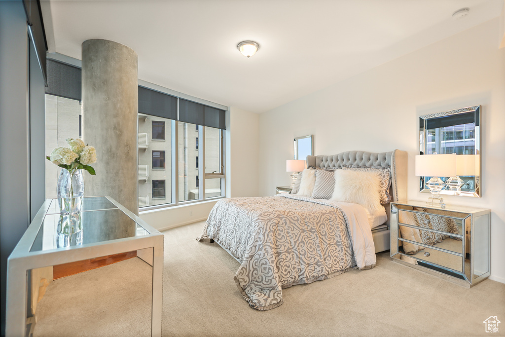 Bedroom featuring carpet and baseboards