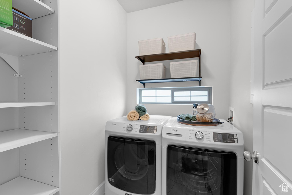 Laundry room featuring washer and clothes dryer