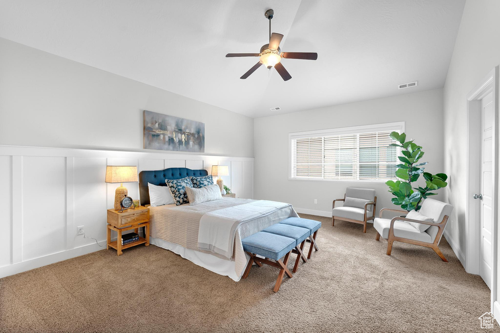Carpeted bedroom with ceiling fan and baseboards