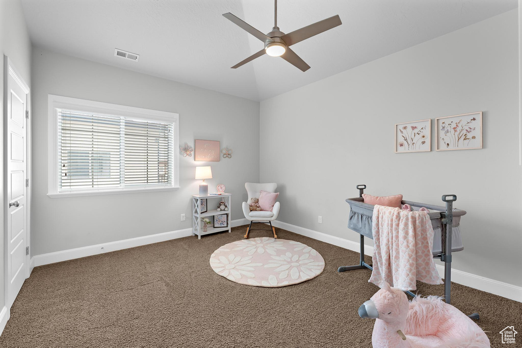 Sitting room featuring carpet, ceiling fan, vaulted ceiling, and baseboards