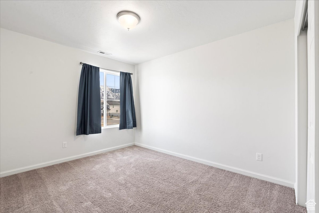 Spare room with carpet flooring and baseboards