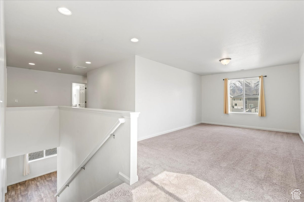 Spare room with recessed lighting, baseboards, and carpet floors