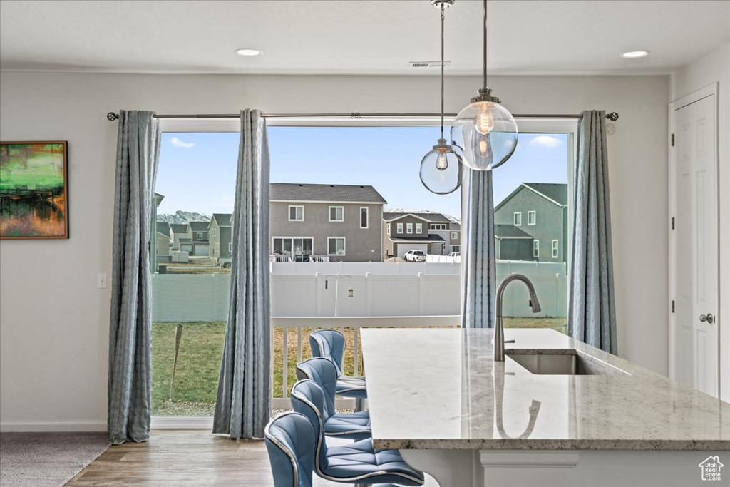 Dining space featuring baseboards, wood finished floors, and recessed lighting
