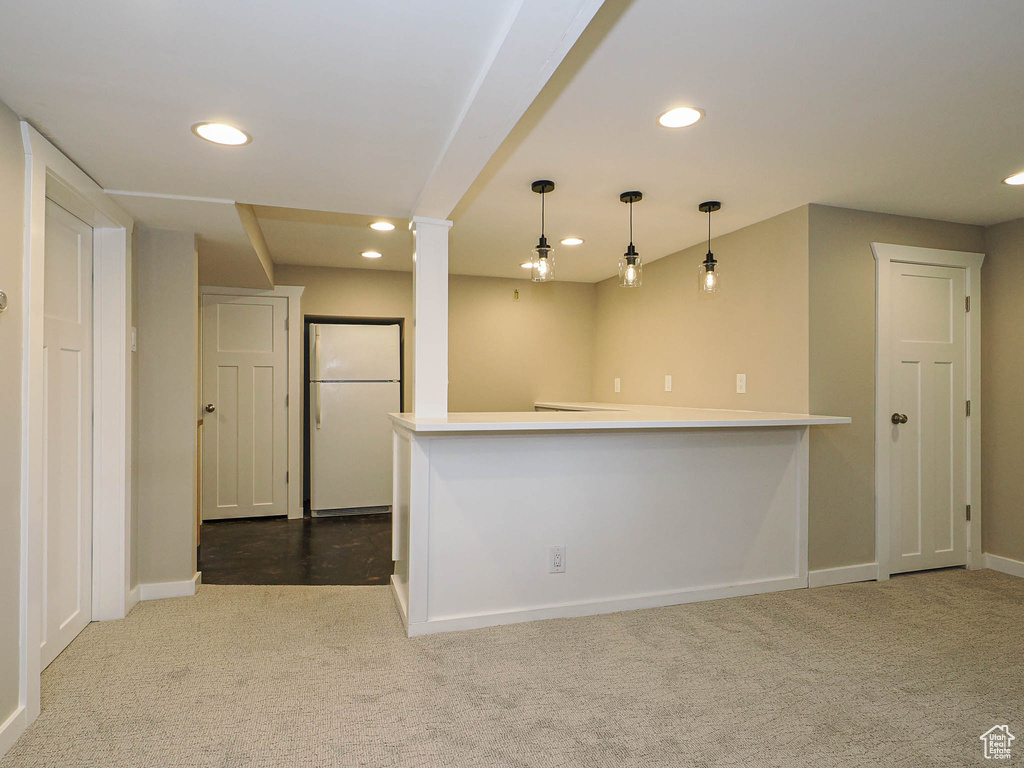 Kitchen featuring freestanding refrigerator, carpet flooring, recessed lighting, baseboards, and decorative light fixtures