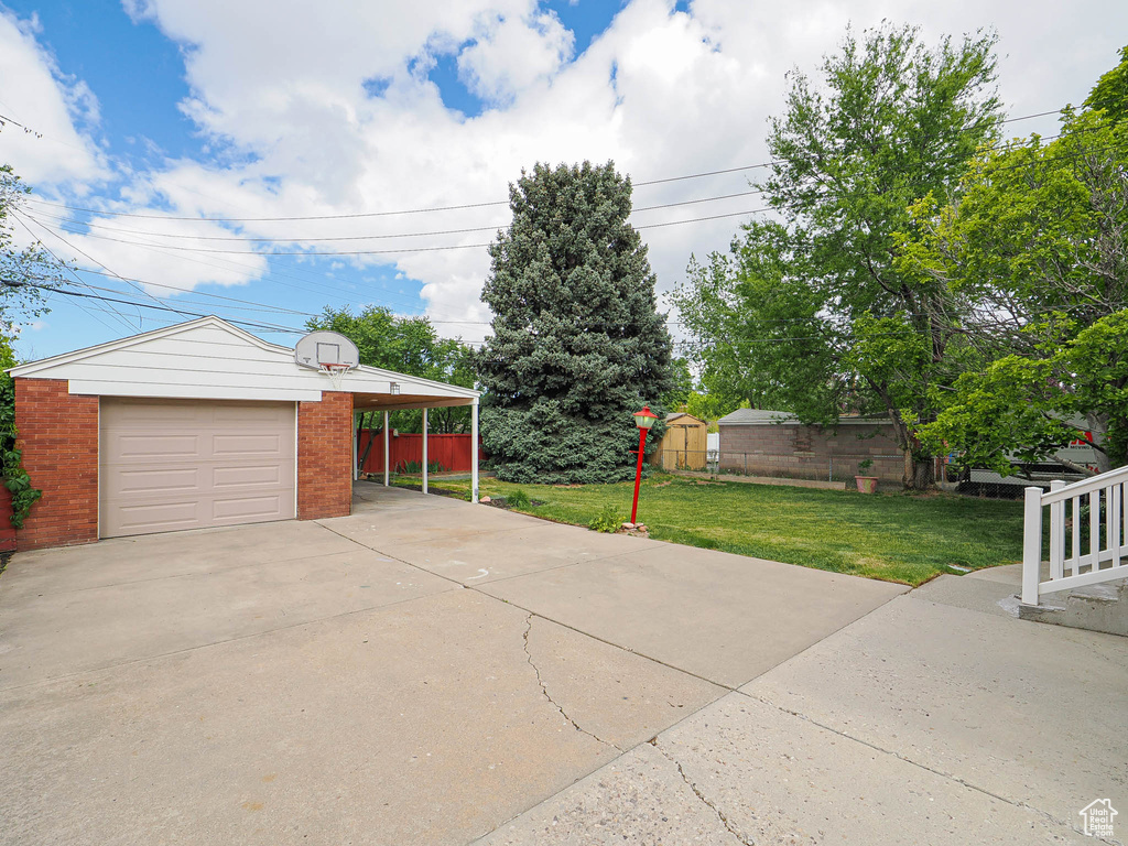 Garage featuring concrete driveway