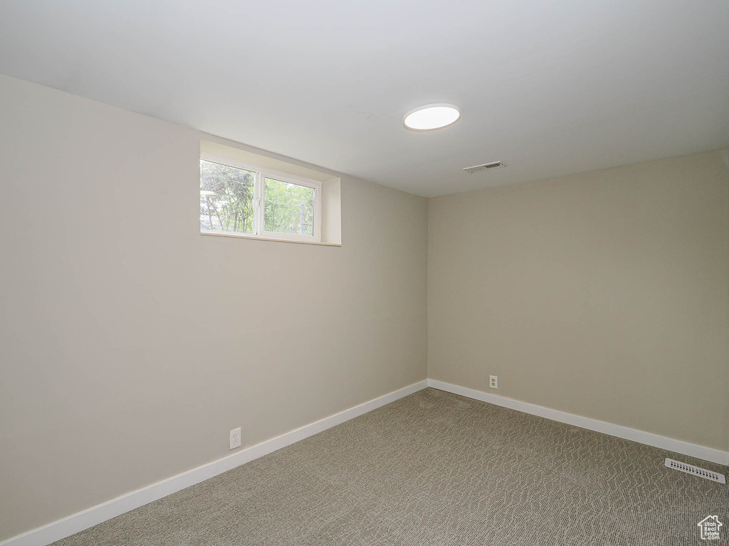 Empty room with baseboards and carpet floors