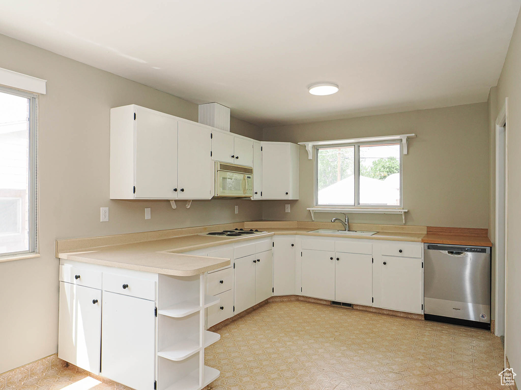 Kitchen featuring white appliances, open shelves, a sink, and white cabinetry