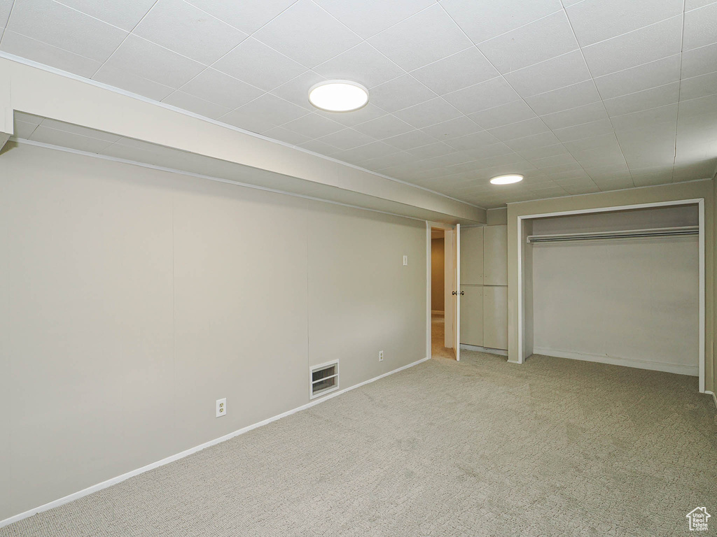 Unfurnished bedroom featuring carpet, baseboards, and a closet